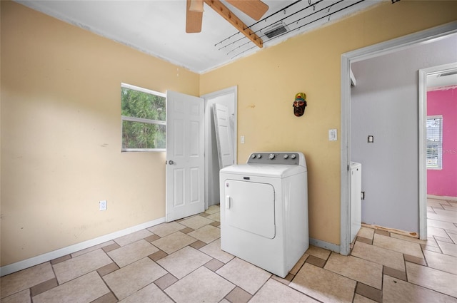 laundry room with ceiling fan and washer / dryer