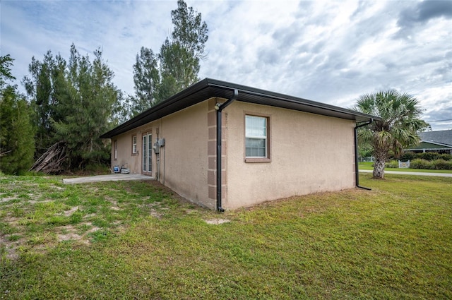 view of side of home featuring a lawn