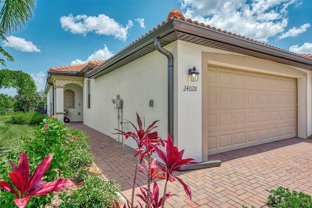 view of side of home featuring a garage