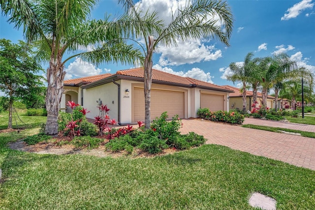 mediterranean / spanish-style house with a front lawn and a garage