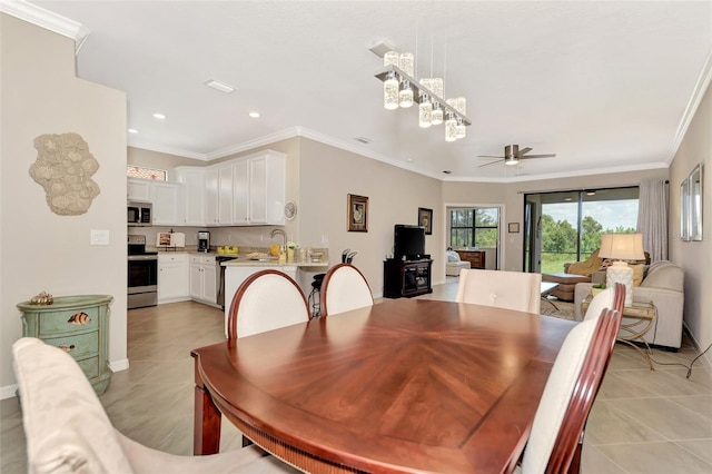 dining room with ceiling fan, crown molding, sink, and light tile patterned floors