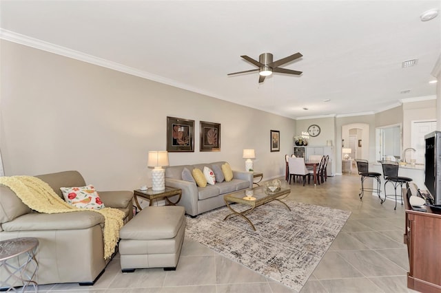 living room featuring ceiling fan, ornamental molding, and light tile patterned floors