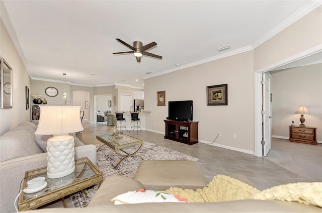 tiled living room featuring ornamental molding and ceiling fan