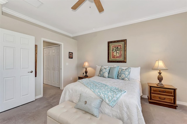 carpeted bedroom with a closet, ceiling fan, and crown molding