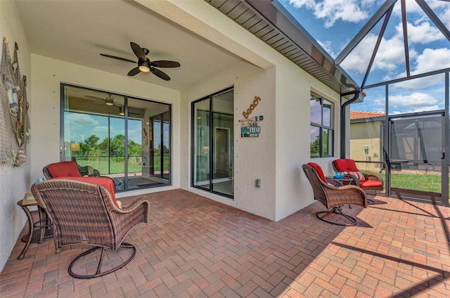 view of patio / terrace with ceiling fan and a lanai