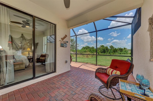 sunroom / solarium featuring ceiling fan