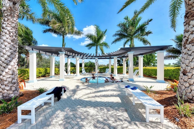 view of home's community with a pool, a patio, and a pergola