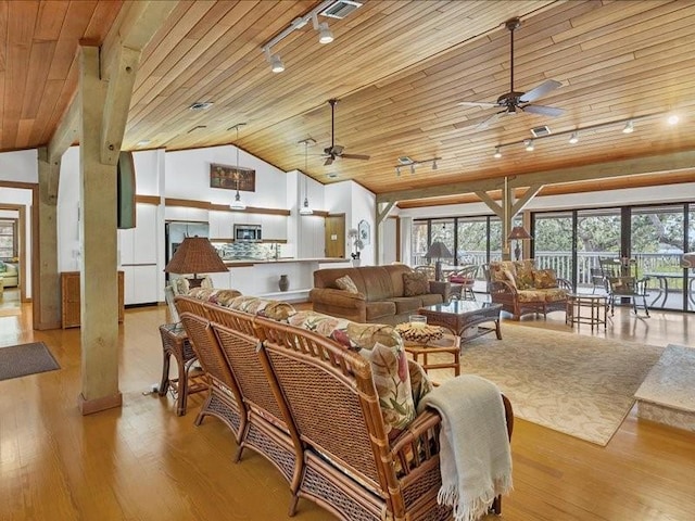 living room with vaulted ceiling, plenty of natural light, wooden ceiling, and light hardwood / wood-style floors