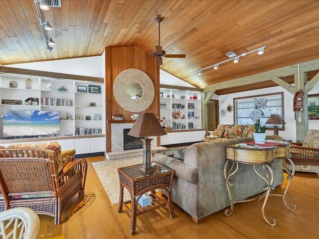 living room featuring wood ceiling, lofted ceiling, built in features, and light hardwood / wood-style flooring