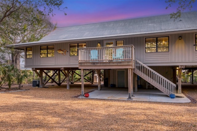 view of back house at dusk