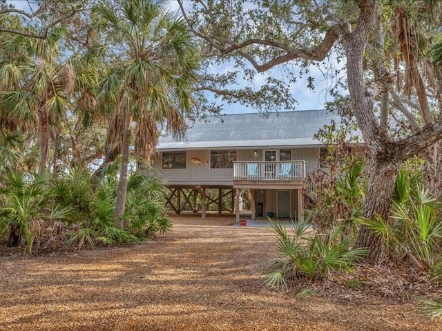 back of property with a carport