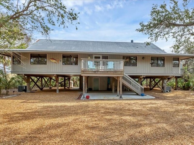 back of property featuring central AC