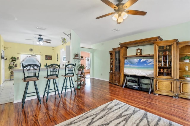 living room featuring dark hardwood / wood-style floors and ceiling fan