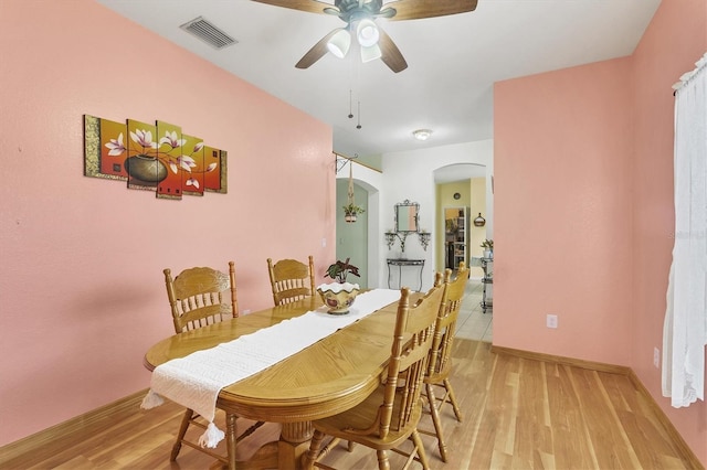 dining area with light hardwood / wood-style flooring and ceiling fan