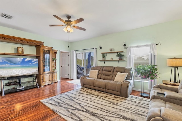 living room with ceiling fan and hardwood / wood-style floors