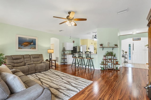 living room with ceiling fan and light wood-type flooring