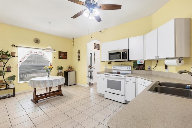 kitchen featuring white cabinets, decorative light fixtures, sink, and white range with electric stovetop