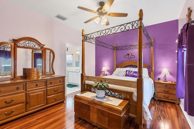 bedroom with ensuite bathroom, hardwood / wood-style floors, and ceiling fan