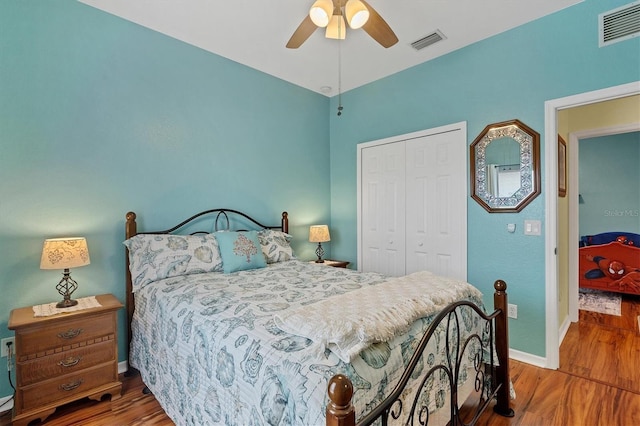 bedroom with wood-type flooring, a closet, and ceiling fan