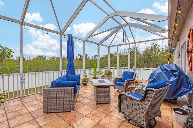 view of patio / terrace featuring grilling area, a lanai, and an outdoor living space with a fire pit