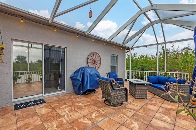 view of patio / terrace with grilling area, an outdoor hangout area, and glass enclosure