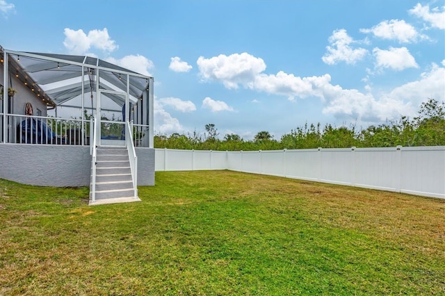 view of yard with glass enclosure