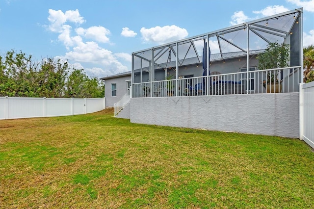 rear view of property featuring a lawn and glass enclosure