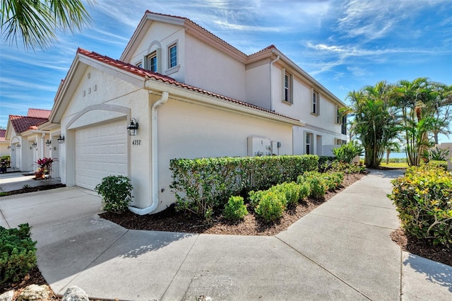 view of side of home featuring a garage