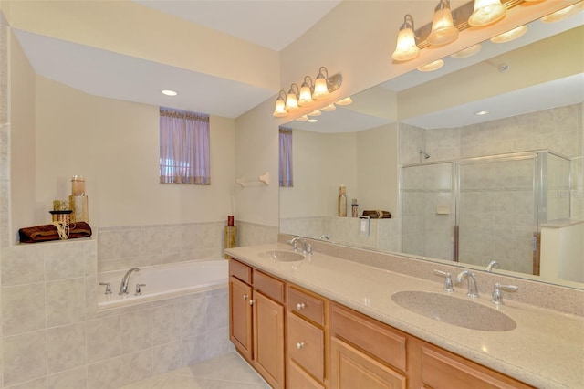 bathroom with tile patterned floors, independent shower and bath, and vanity