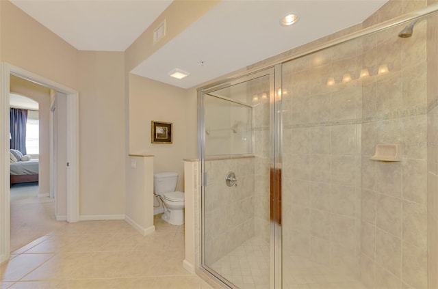 bathroom with walk in shower, tile patterned floors, and toilet