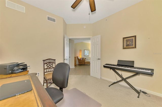 carpeted office space with ceiling fan