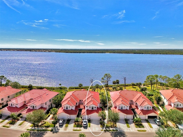 birds eye view of property with a water view