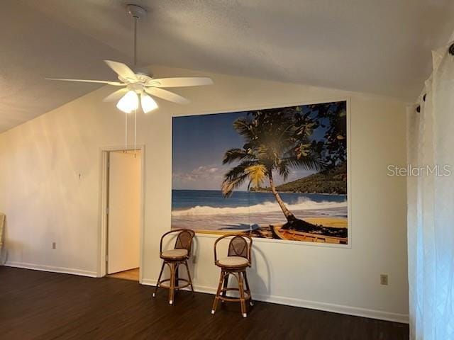 dining room with lofted ceiling, dark wood-style floors, baseboards, and a ceiling fan