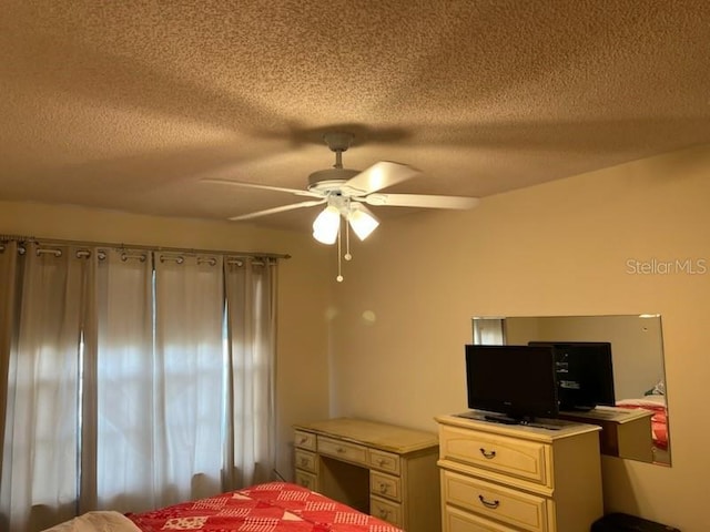 bedroom with a textured ceiling and a ceiling fan