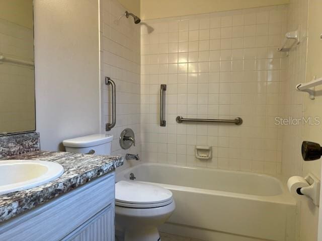 bathroom featuring bathtub / shower combination, vanity, and toilet