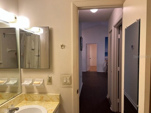 bathroom with a textured ceiling and vanity