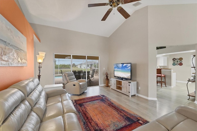 living room with ceiling fan, light hardwood / wood-style flooring, and high vaulted ceiling