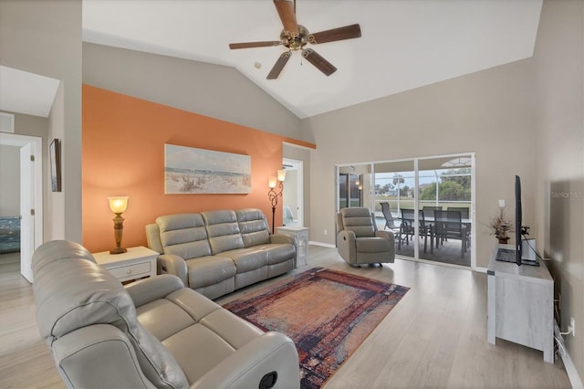 living room featuring ceiling fan, lofted ceiling, and light hardwood / wood-style floors