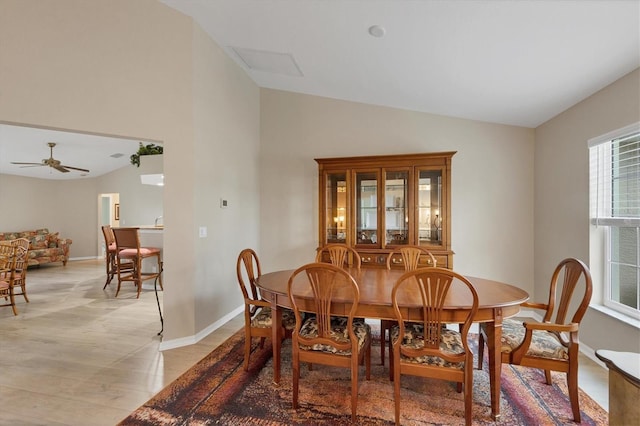 dining area with ceiling fan and vaulted ceiling