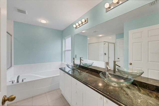 bathroom featuring vanity, tile patterned floors, and plus walk in shower