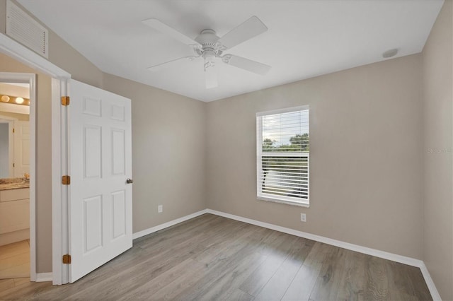 unfurnished room with light wood-type flooring and ceiling fan