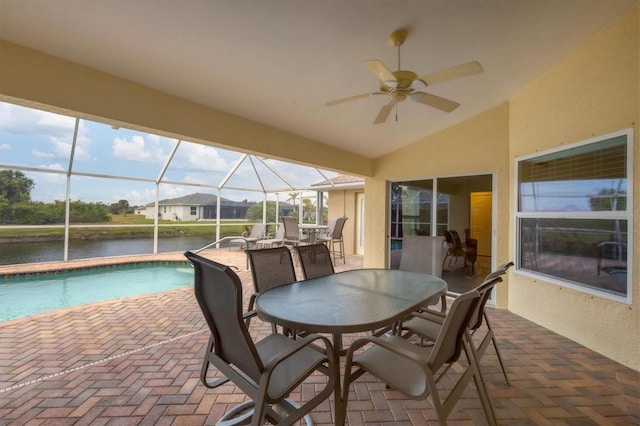 sunroom with ceiling fan, a swimming pool, lofted ceiling, and a water view