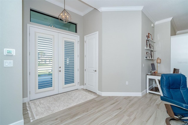 entryway featuring ornamental molding, light hardwood / wood-style flooring, and an inviting chandelier