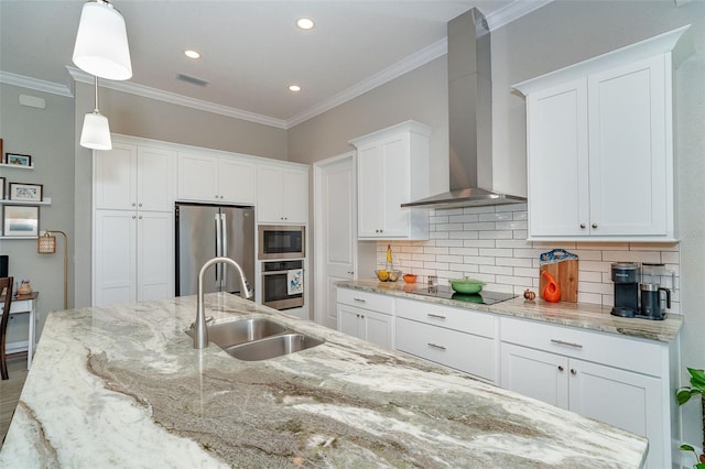 kitchen featuring pendant lighting, stainless steel appliances, wall chimney range hood, white cabinetry, and sink