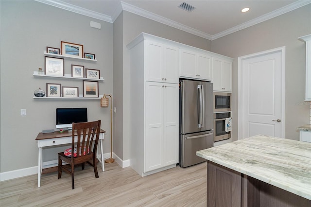 kitchen featuring appliances with stainless steel finishes, white cabinets, crown molding, and light stone countertops