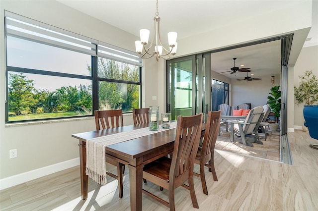 dining space featuring ceiling fan with notable chandelier