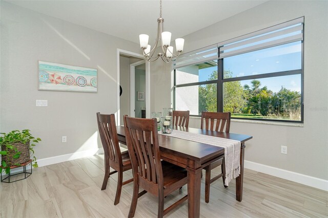 dining room featuring a chandelier and light wood-type flooring