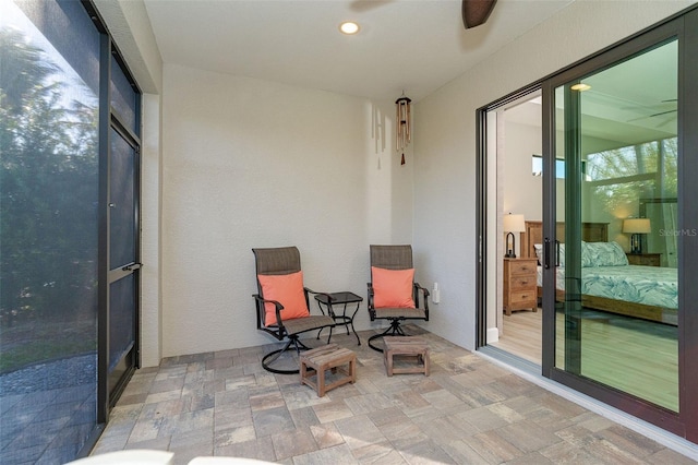 sunroom / solarium with ceiling fan