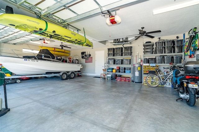 garage featuring water heater, a garage door opener, and ceiling fan