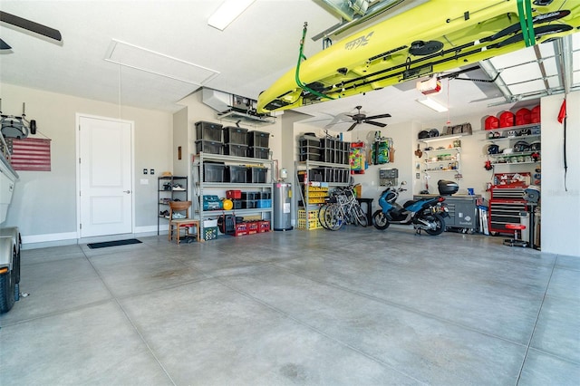 garage featuring a garage door opener, ceiling fan, and electric water heater